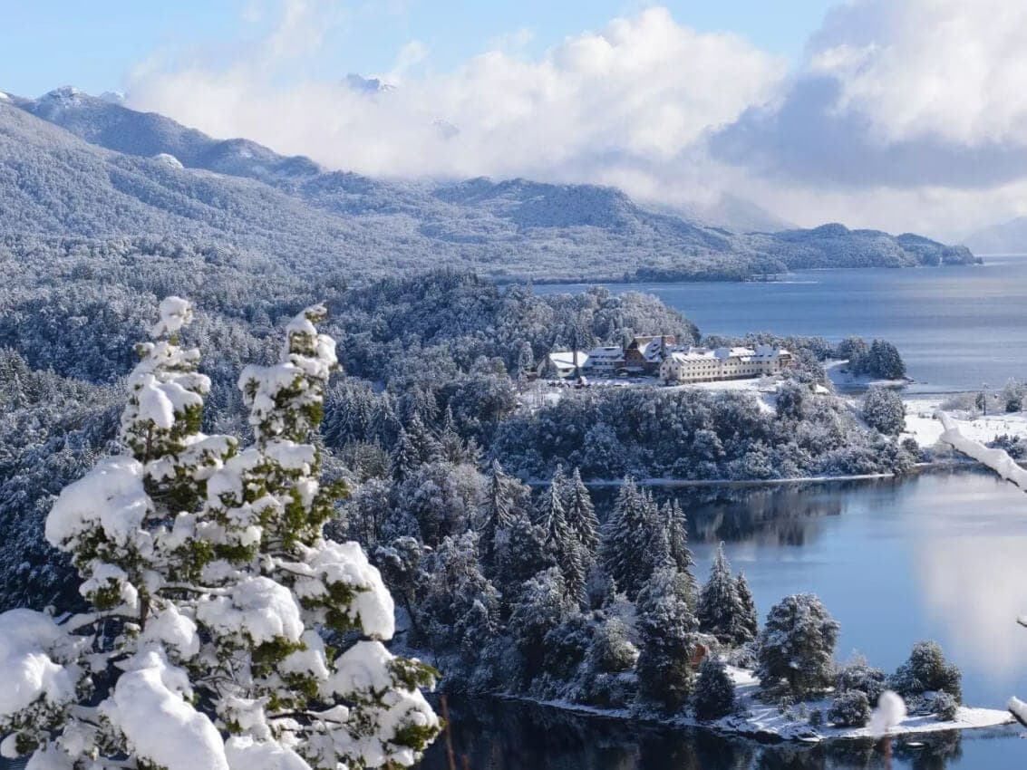 El lago Nahuel Huapi y el bosque nevados desde el Circuito Chico, con el hotel Llao Llao sobre la península.